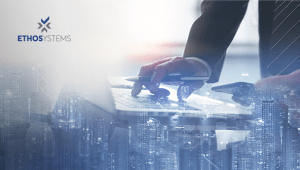 buildings with overlay of hands typing on laptop