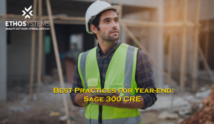 construction worker with ipad on site surrounded by wooden framing looking into distance