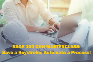 Construction worker at desk with plans and helmet typing on laptop