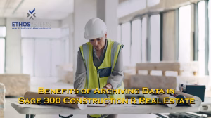 construction worker looking at computer and papers