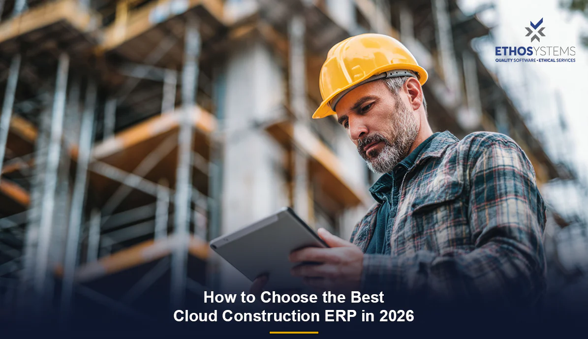 Contractor using a laptop on-site to review cloud construction ERP software