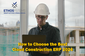 Contractor using a laptop on-site to review cloud construction ERP software