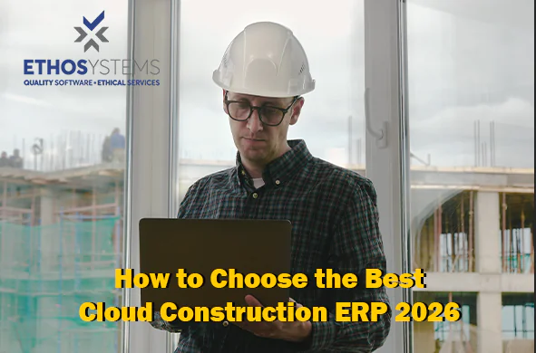 Contractor using a laptop on-site to review cloud construction ERP software