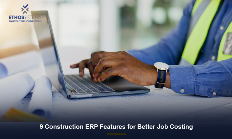 Construction contractor reviewing job cost data using construction ERP software on a laptop